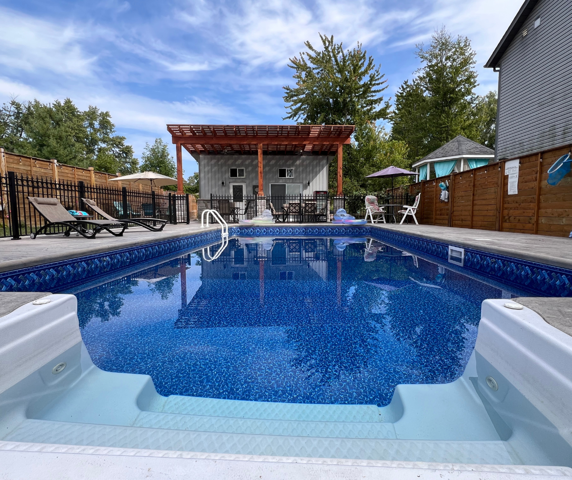 Outdoor heated pool at Malak BnB Resort with lounge chairs