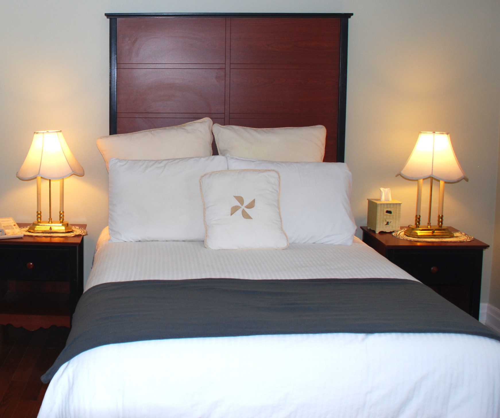 Cozy queen bed with elegant warm lighting