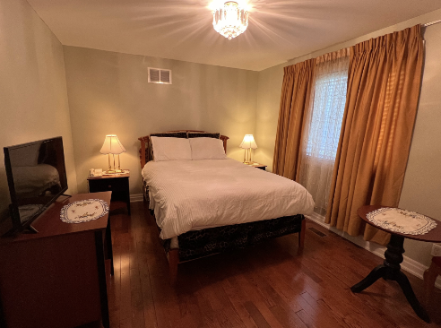 Standard queen bed room with warm lighting