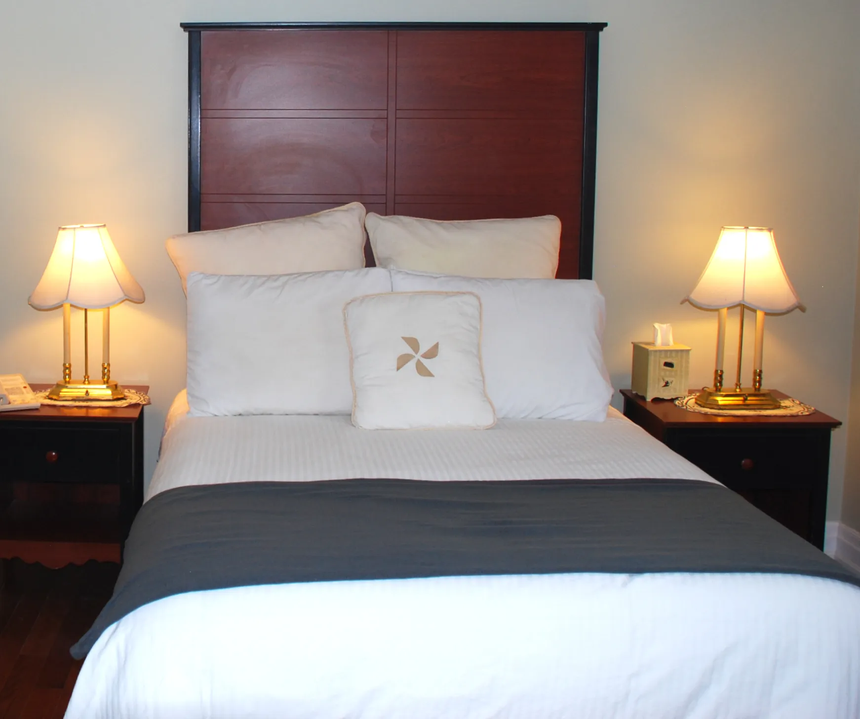 Cozy queen bed with elegant warm lighting